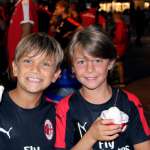Two children eat ice cream during the AC Milan summer holidays