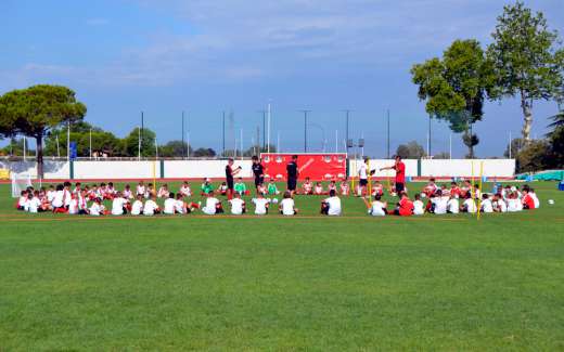 Young players of the AC Milan Academy Camp in the half-circle while receiving instructions from Sporteventi's technical staff