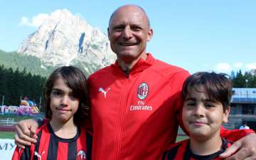 Pietro Vierchowod, ex giocatore dell'AC Milan e allenatore, con due bambini del Milan Junior Camp