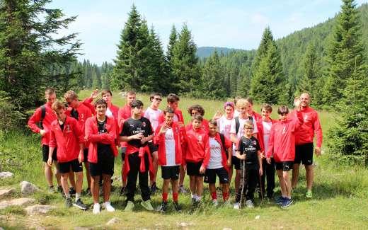 Boys walk in the woods of the Asiago Plateau during the AC Milan summer camp
