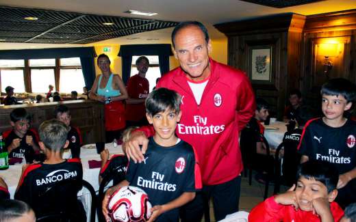 Walter De Vecchi in the dining room of the hotel in Cortina d'Ampezzo with a child and other kids during the AC Milan Academy Camp