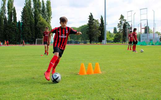 Four boys practice dribbling during the AC Milan Junior Camp in Jesolo, Venice