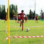 Sei ragazzi svolgono degli esercizi durante l'allenamento di calcio al Milan Junior Camp nello stadio di Jesolo (Venezia)