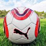 Soccer ball on the synthetic turf of the playing field of the AC Milan Academy Camp in Lignano Sabbiadoro