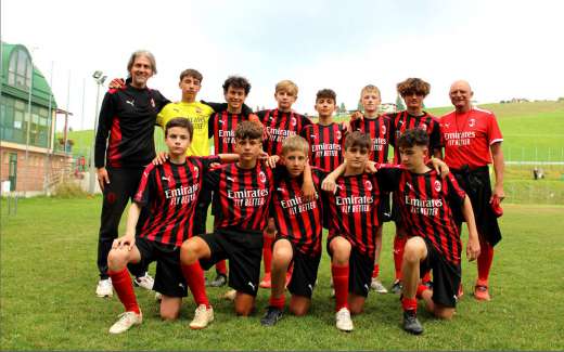 Coach Pietro Vierchowod and Technical Director Lorenzo Cresta with eleven boys from the AC Milan summer soccer camp at the Gallio sports field on the Asiago plateau