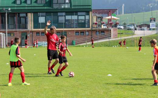 The technical director Lorenzo Cresta trains the boys of the AC Milan Academy Camp in the football field in the Asiago plateau