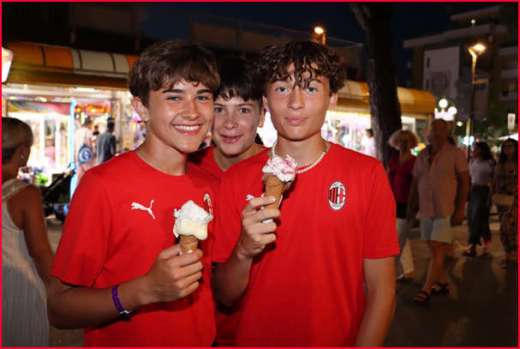 Tre ragazzi dell'AC Milan Camp gustano un gelato durante la passeggiata serale a Lignano Sabbiadoro