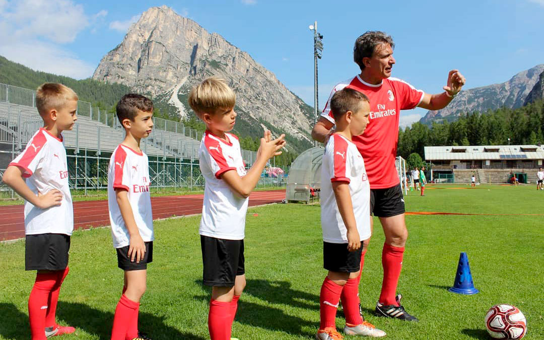 During the training in the AC Milan Junior Camp, il supervisore AC Milan, the head coach Stefano Eranio gives the instructions to four children
