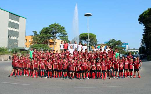 Boys and girls of the AC Milan soccer football camp near the fountain in the place of Lignano Sabbiadoro (Seaside)
