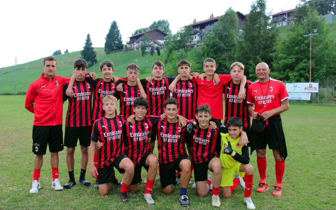 Youth football players with Pietro Vierchowod on the soccer field of Asiago Plateau during the AC Milan Junior Camp